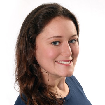 Headshot of Nicole Brooks in a blue shirt against a white background.