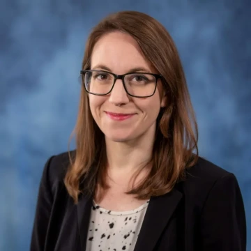 portrait of Carolyn Barnett against a blue background