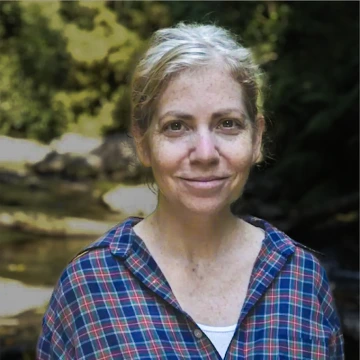 Stacey Tecot portrait outdoors in front of a stream