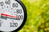 A round thermometer shows the outdoor temperature crossing the 100-degree threshhold.